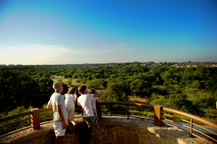 Kids enjoy the view from observation tower at Arbor Hills Nature Preserve in Plano, Texas.