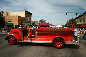 Children plan on an old fire truck in Spearfish, SD.