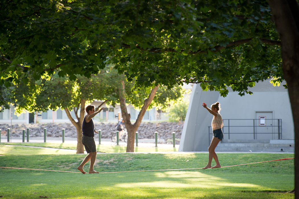 A couple walks across a slackline at a park in Richland, WA.