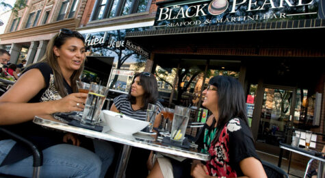 Three women dine outside the Black Pearl in Ann Arbor