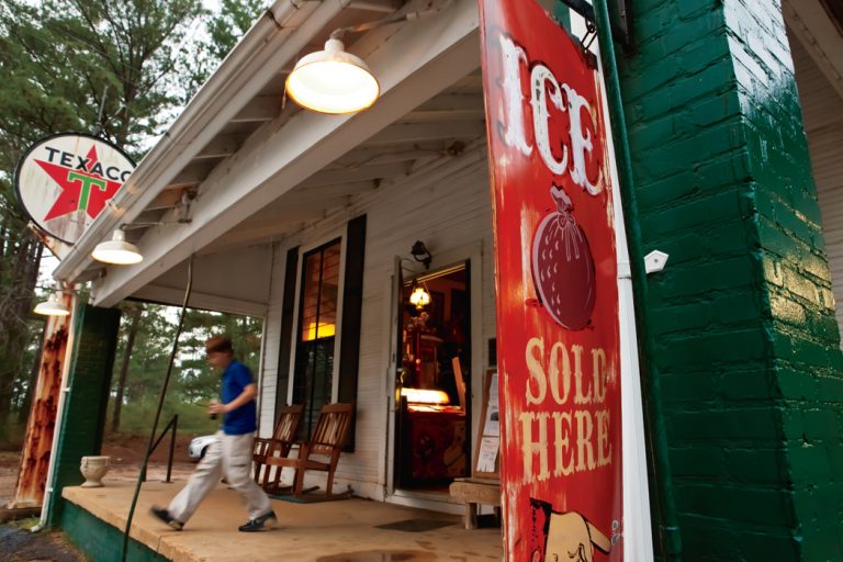 A boy walks out of the Causeyville General Store, an old southern store in Meridian, MS.