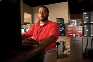 Software Quality Assurance Engineer Seneca Pattaway programs a software program at Circadence.