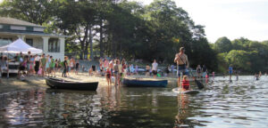 People play on the beach at Crystal Lake in Newton, MA