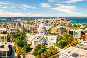 Wisconsin State Capitol and Madison skyline panorama. The Wisconsin State Capitol, houses both chambers of the Wisconsin legislature, Supreme Court and the Office of the Governor.