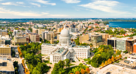 Wisconsin State Capitol and Madison skyline panorama. The Wisconsin State Capitol, houses both chambers of the Wisconsin legislature, Supreme Court and the Office of the Governor.