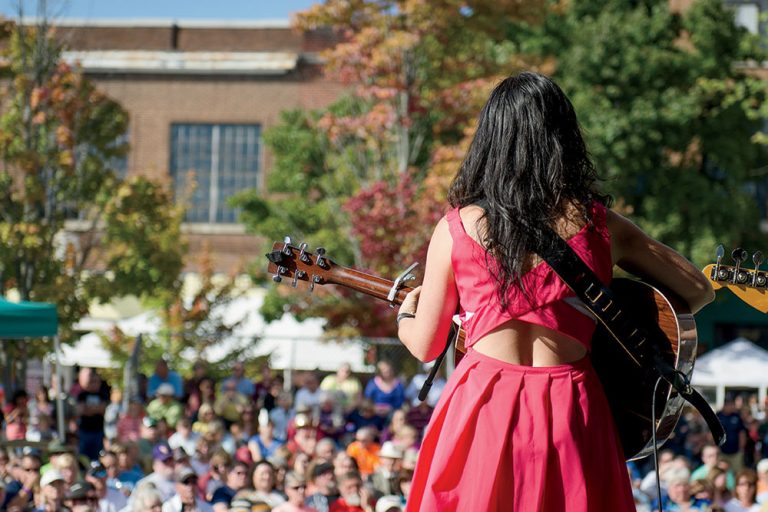 Woman playing guitar at Bristol Rhythm and Roots Reunion in Bristol TN