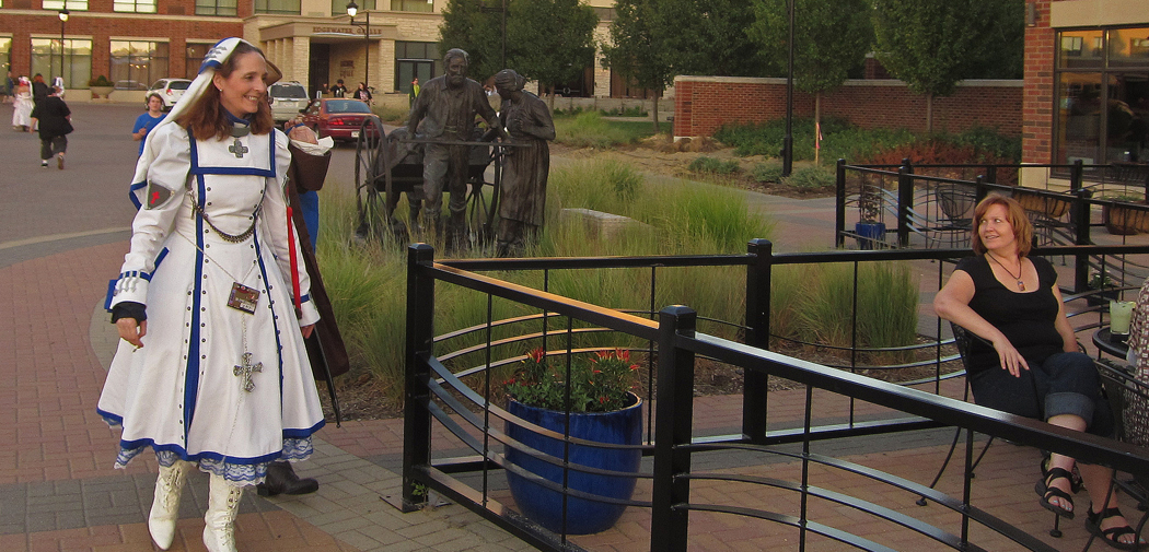 A costumed convention goer who is dressed as a nurse walks around Coralville, Iowa.
