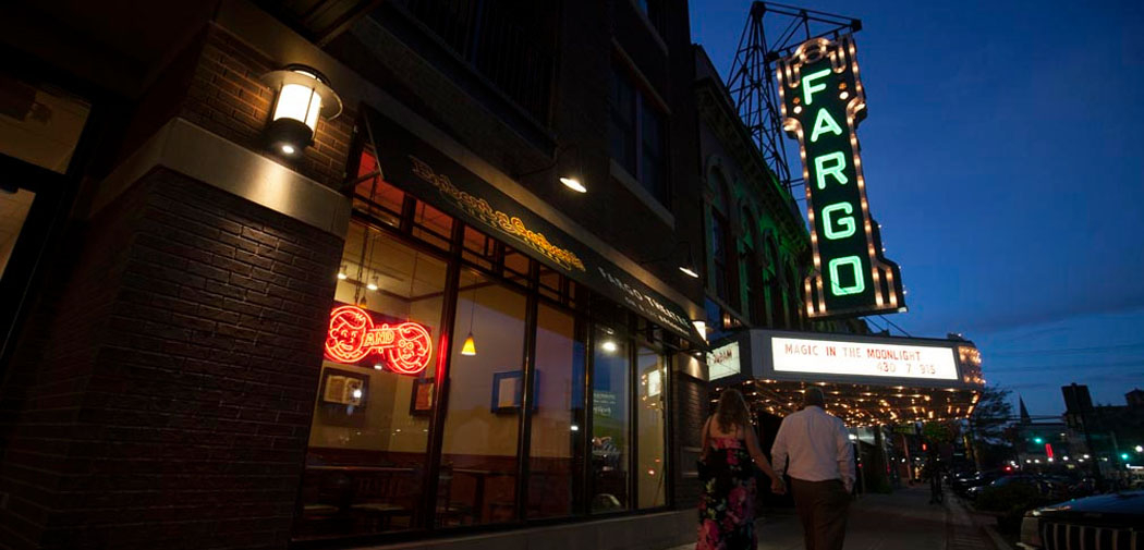 The marquee for the Fargo Theatre lights up at dusk along North Broadway Drive in downtown Fargo, North Dakota.