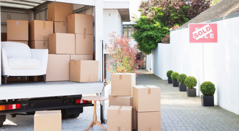 Stock image of moving boxes by a moving truck.