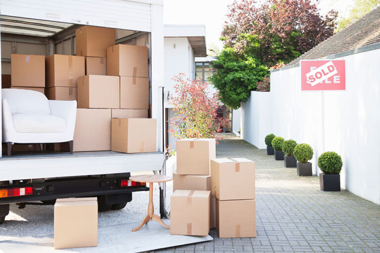 Stock image of moving boxes by a moving truck.