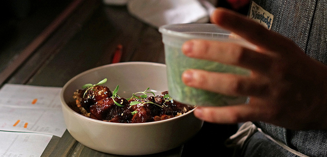 a chef at eating house miami prepares a dish for order.