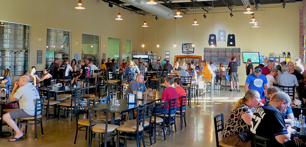 Visitor sample beers in the taproom at Confluence Brewing Company