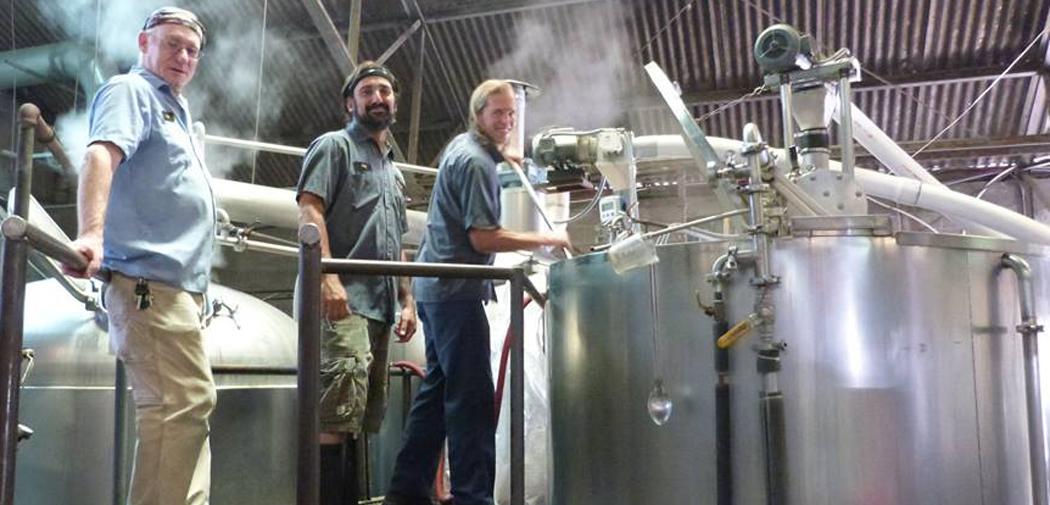 Brewers at Nola clean a giant beer vat.
