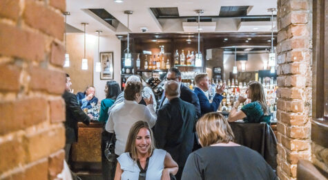 Group of people dining inside of Worcester's Nuovo restaurant
