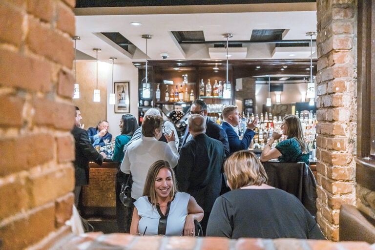 Group of people dining inside of Worcester's Nuovo restaurant