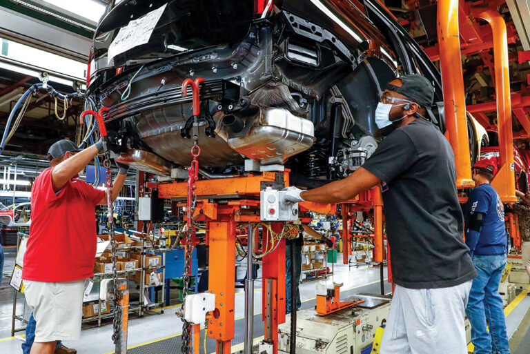 Men work on the assembly line for General Motors, which is part of the Nashville area's state of innovation.