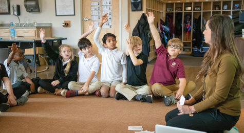 students raising their hands