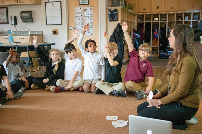 students raising their hands