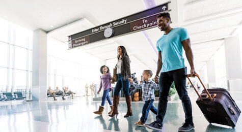 Family walking through airport