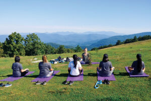 Women doing yoga on a mountain