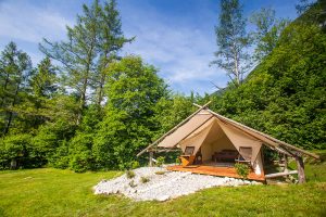 Glamping tent exterior with all amenities in Adrenaline Check eco camp in Slovenia.