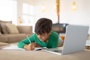 boy using laptop to study
