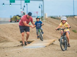 Family biking in Las Colonias Park