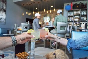 Couple clinks together craft spirit drink the Rising Sun from Marble Distilling Co. in Colorado