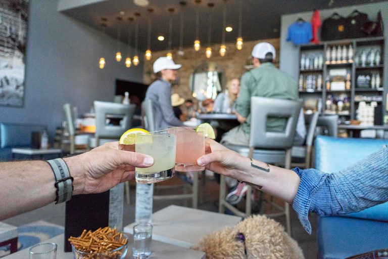 Couple clinks together craft spirit drink the Rising Sun from Marble Distilling Co. in Colorado