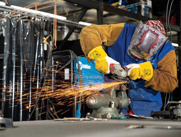 A student uses an angle grinder during a welding at the FutureForward campus in Adams County, CO.