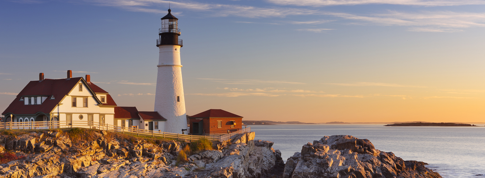 The Portland Head Lighthouse in Maine at sunrise.