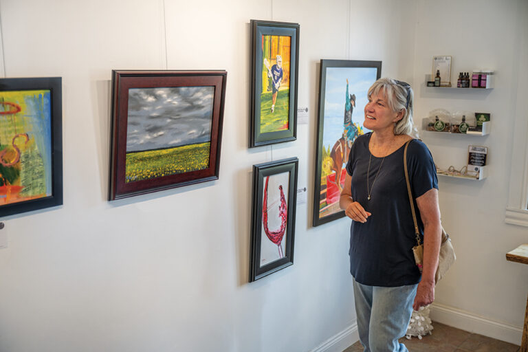 Castle Rock, CO: Woman taking in an exhibit 2022 Rhyolite Gallery ©Journal Communications/Colin Shreffler