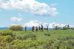 Castle Rock, CO: People walking on a zip line tour with mountains in the background.