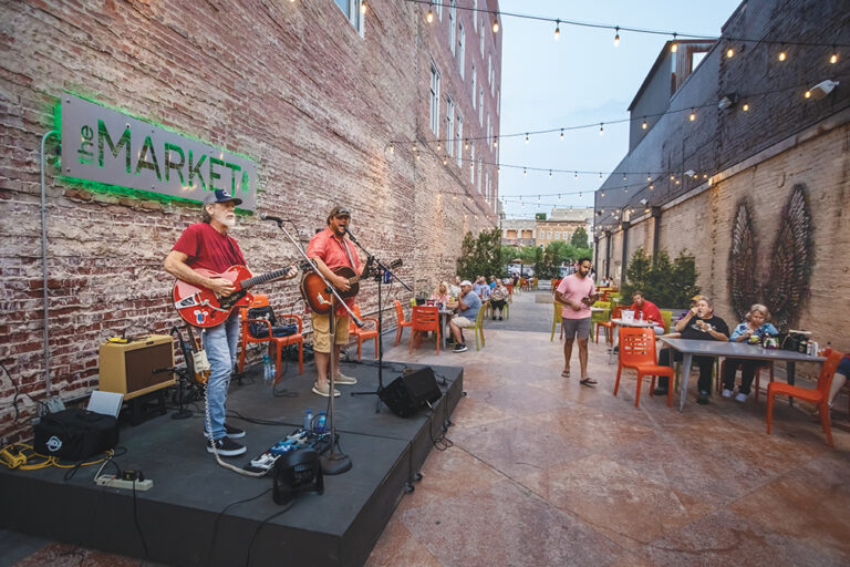 Musician Barry Frazee performs for the crowd in the outdoor courtyard at The Market in downtown Huntington, West Virginia. Huntington is located in the Advantage Valley region of West Virginia.