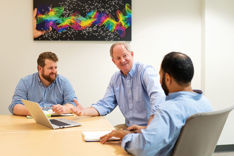 A team of men meet at QUBIC Labs in Quincy, MA.