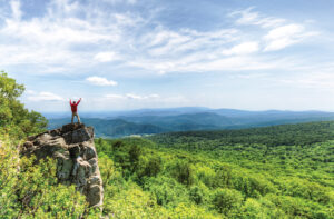 Person stands on top of a mountain at Shenandoah National Park, which is located in Central Virginia.