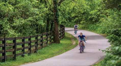 Children ride their bike along the trail at River Park in Brentwood in Williamson County.