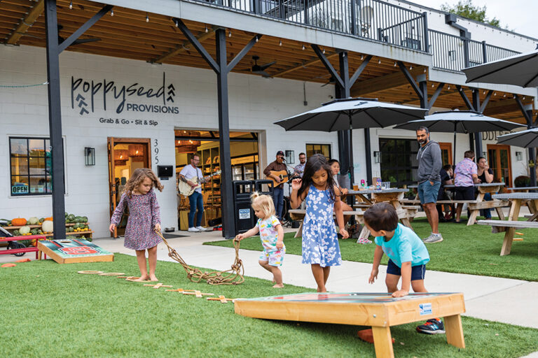Children play outside at Poppyseed Provisions, Winston Salem, NC.