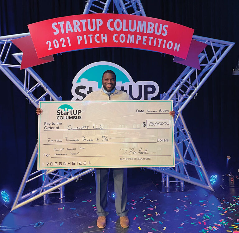 Jay Pitts, president and CEO of ClinCept, holds the winning check at the 2021 Pitch Competition.