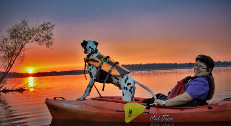 A man kayaks with his dog in New Castle, Indiana.