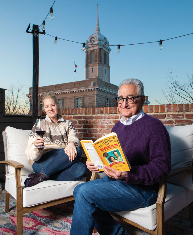 Del and Carolyn Bryant enjoy the balcony of the short-term rental they own, All I Have to Do is Dream.