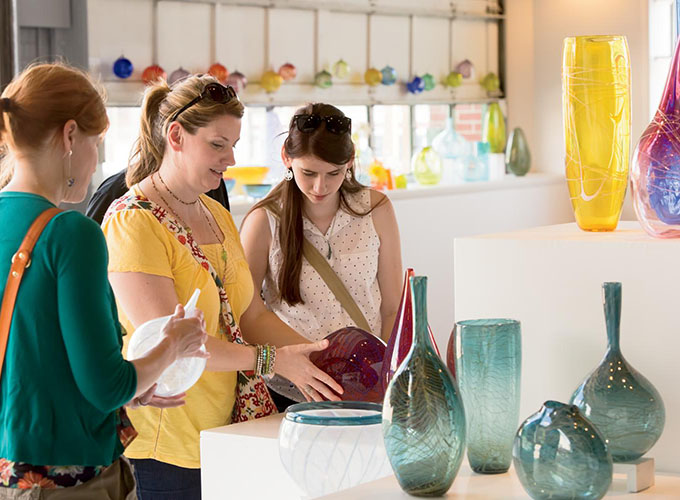 Women shop at Lexington Glassworks in downtown Asheville, N.C. A penchant for art and more than 300 locally-owned shops and restaurants make Asheville one of the best places to live in the U.S..