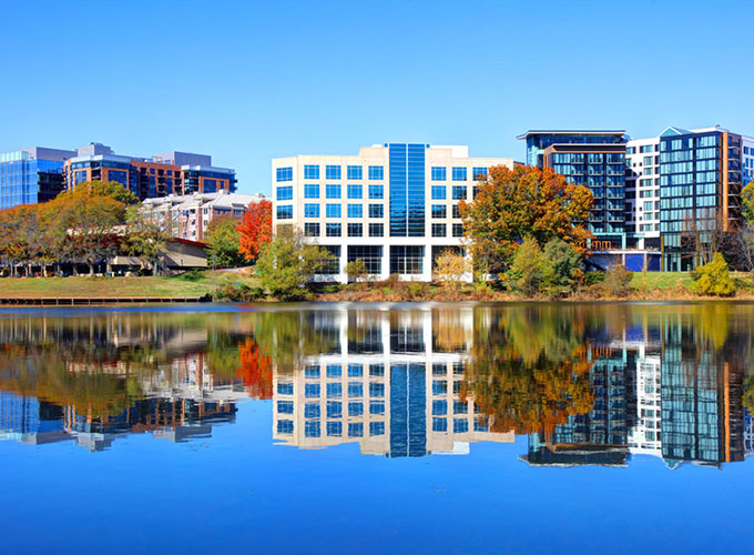 Office buildings along the water in Columbia, MD. Businesses there enjoy a central location between Baltimore and Washington, D.C. and a talent pipeline with highly educated workers.