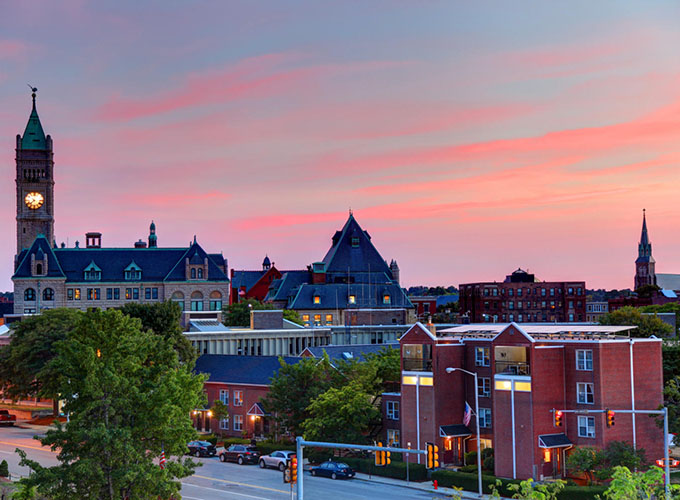 An aerial view of downtown Lowell, MA. Lowell has a thriving arts scene, cobblestone streets, and a bustling downtown.