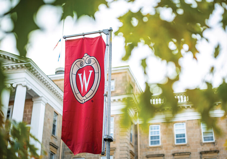 A W crest banner on Bascom Hill is pictured among the colors of the fall leaves at the University of Wisconsin-Madison during autumn on November 8, 2021. (Photo by Bryce Richter / UW-Madison)