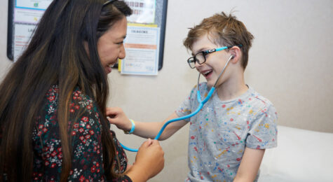 Mosaic Family Health doctor meets with a child.