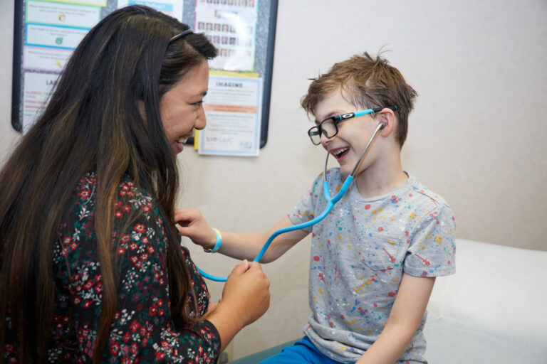 Mosaic Family Health doctor meets with a child.