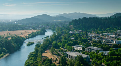 Aerial shot of the Willamette River flowing through Eugene, Oregon on a sunny day in summer.