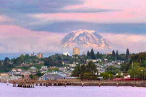 Mount Rainier over Tacoma, Washington waterfront during alpenglow sunset evening.